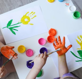 Niños pintando sus manos con colores